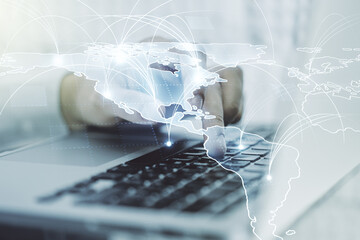 Double exposure of abstract digital world map with connections and hand typing on computer keyboard on background, big data and blockchain concept