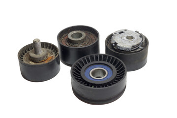 tensioner, idlers, pulleys of car actuators of engine and alternator. worn out rollers of car drive mechanisms, dismantled, case of replacing. on white background
