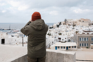 Naxos island top view on houses, man taking pictures