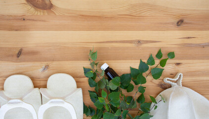 bathhouse, traditional sauna accessories: birch broom, felt hat, felt slippers. Traditional Russian bathhouse. SPA Concept. Relax country village bath concept. free copy space