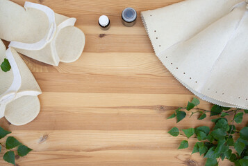 bathhouse, traditional sauna accessories: birch broom, felt hat, felt slippers. Traditional Russian bathhouse. SPA Concept. Relax country village bath concept. free copy space
