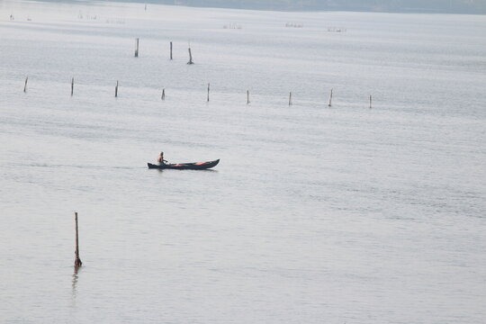 fisherman fishing on traditional fishing boat
