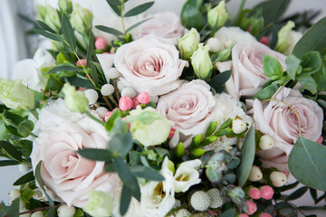 bridal bouquet in boho, rustic style. bouquet of soft pink roses, eustomas and eucalyptus branches