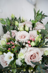 bridal bouquet in boho, rustic style. bouquet of soft pink roses, eustomas and eucalyptus branches