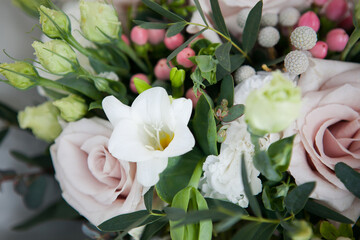 bridal bouquet in boho, rustic style. bouquet of soft pink roses, eustomas and eucalyptus branches