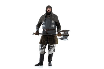 Portrait of brutal brave man in costume of medieval warrior, knight posing isolated over white studio background