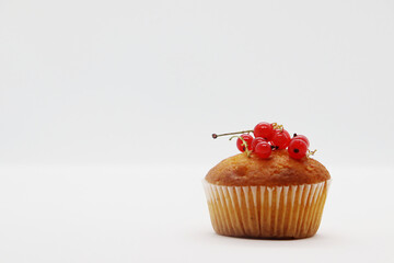 Sweet cupcake with berries on a white background