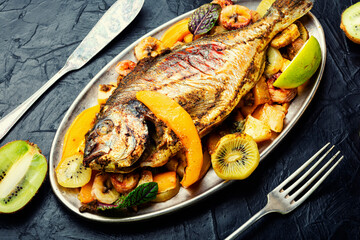 Baked fish dorado with pineapple, mango and kiwi.