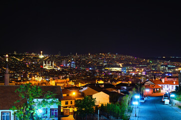 Naklejka premium Picturesque aerial night light landscape view of Ankara. Illuminated high-rise buildings on the horizon. View from the hill near Ankara Castle. Travel and tourism concept