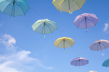 Fototapeta na wymiar Colorful umbrellas background. Colorful umbrellas in the sky.