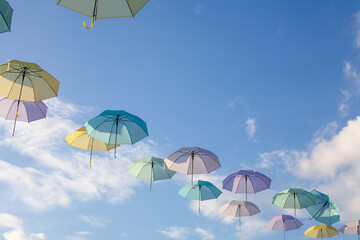 Fototapeta na wymiar Colorful umbrellas background. Colorful umbrellas in the sky.