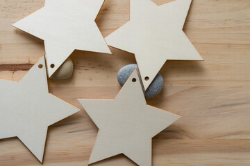 wooden star ornaments or shapes on stones and wood