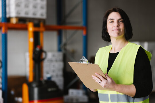 Woman taking notes while checking supplies