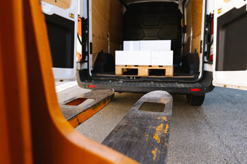 Manual stacker near opened truck