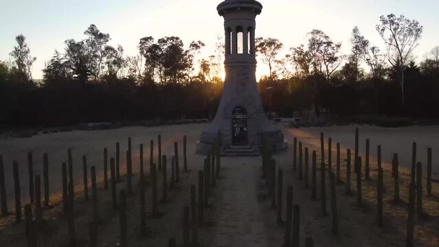 Gothic tower in park of Chapultepec forest Mexico City. Sunset in background with drone aerial view. latin couple in love, model running. Pretty cactus way