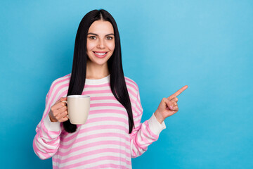 Photo of young pretty girl indicate finger empty space select promo caffeine americano isolated over blue color background