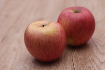Two apples placed on a wooden table , Fruits with vitamin C that are beneficial to the body.