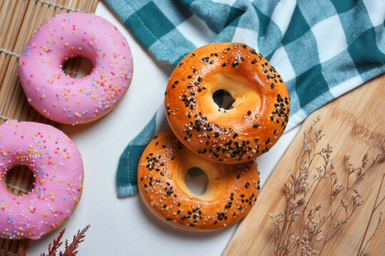 Close-up view of sesame seed and glazed donuts on the table