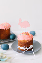 Easter cakes with decorations, colorful eggs and willow branches. Happy Easter holiday concept.