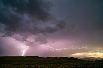 Naklejka na ściany i meble Lightning bolt during storm spanning the landscape