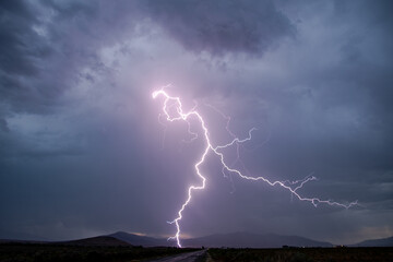 Lightning striking the ground during rain storm