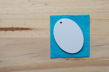 background with oval tag on a blue paper and wood