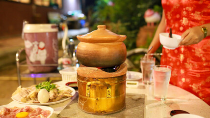 Close-up view of shabu shabu in hot pot. Fresh sliced meat, egg and vegetables, Thailand hotpot style.