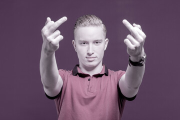 Rude gesture. Antisocial man. Portrait of a red-haired teenager expressing dissatisfaction and...
