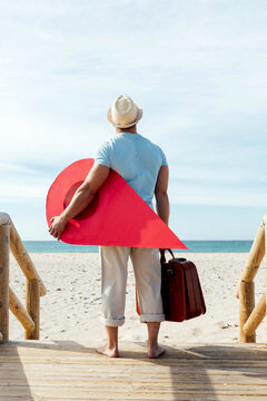Traveling man with red map pointer on boardwalk