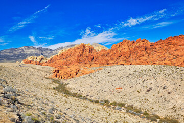 Sharply contrasting red, dark and light rock formations in a valley in Red Rock Canyon Conservation Area, not far from Las Vegas, Nevada
