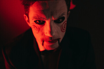 the image of a man from the movie saw on Halloween. The image of a man on Halloween. red lighting