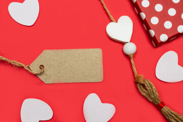 Empty Blank texture canvas paper card, gift box with polka dots and white hearts on a red background. Love valentine concept. Flat lay