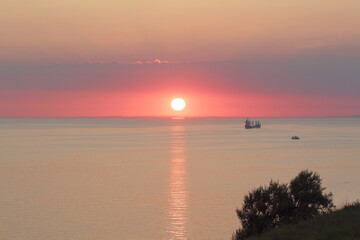 landscape bright sunset over the sea surface and ships