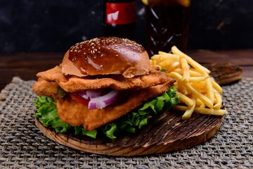 Big hamburger, French fries and vegetables
