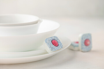 Kitchenware and dishwasher pills. Automatic washing dishes concept