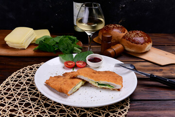chicken schnitzel in a white plate on a wooden table and vegetables