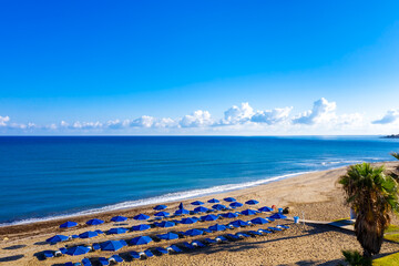 Aerial view of amazing beach with umbrellas, Crete island, Greece. © sola_sola