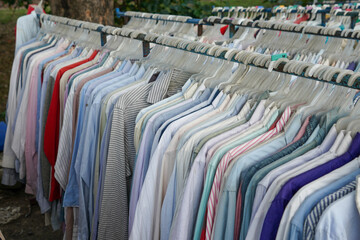 Obraz premium Second hand clothes and pants with quality brands imported from abroad are sold on the roadside at low prices. The clothes and pants are still in good condition and still fit to wear.