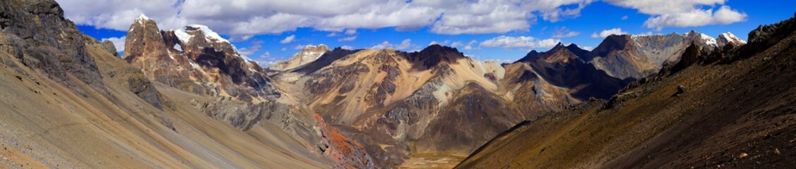 Fototapeta na wymiar Panorama of snowy mountains and valley in the remote Cordillera Huayhuash Circuit near Caraz in Peru.