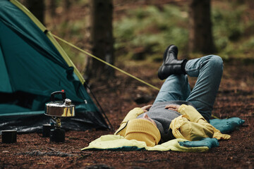 Woman lying on her sleeping bag outdoors
