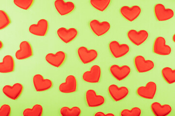 Valentine day green paper background with red hearts background. Valentines day or love concept