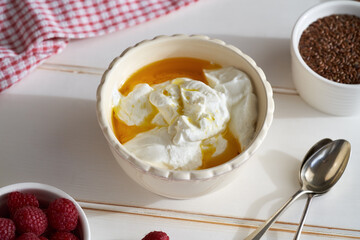Cottage cheese with flax seed oil on bright background. Budwig diet.