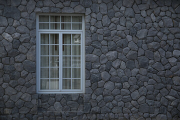wooden window, on a stone wall, with rusticated glass