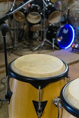 Fototapeta na wymiar Bongo drum with defocused drumkit in background
