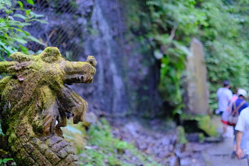 Naklejka na ściany i meble Waterfall and dragon figurine