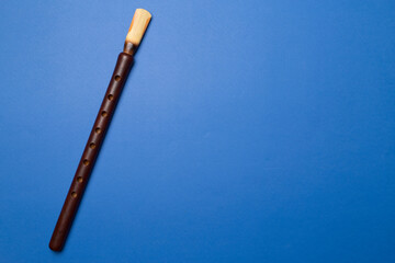 Naklejka premium Armenian national musical instrument duduk on color background. Top view