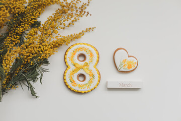 Women's Day, March 8, figure eight, gingerbread, flowers. Space for text.
