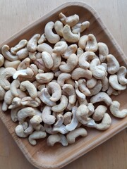 Cashew nuts on a wooden plate