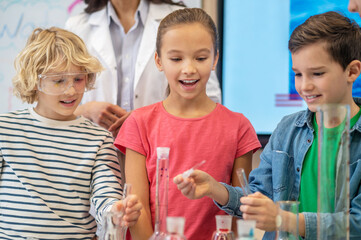 Children doing liquid experiment in chemistry class