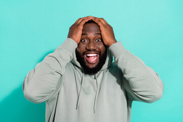 Portrait of attractive cheerful overwhelmed guy news reaction win lottery isolated over bright teal...
